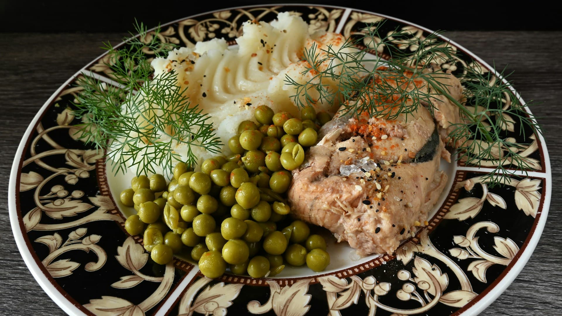 A close-up of a heart-healthy meal with salmon, quinoa, and a green salad.