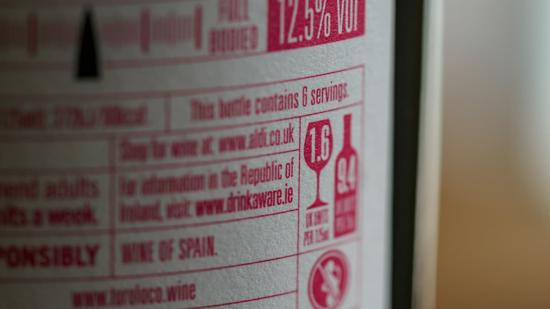 A close-up of a nutritional label on a protein powder container, highlighting the ingredients list.