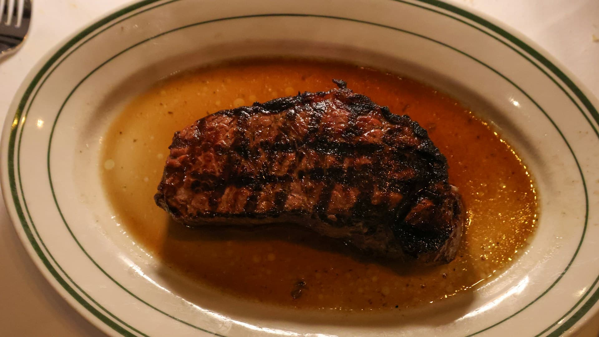 A close-up of a perfectly cooked ribeye steak on a plate, representing a meal on the carnivore diet.
