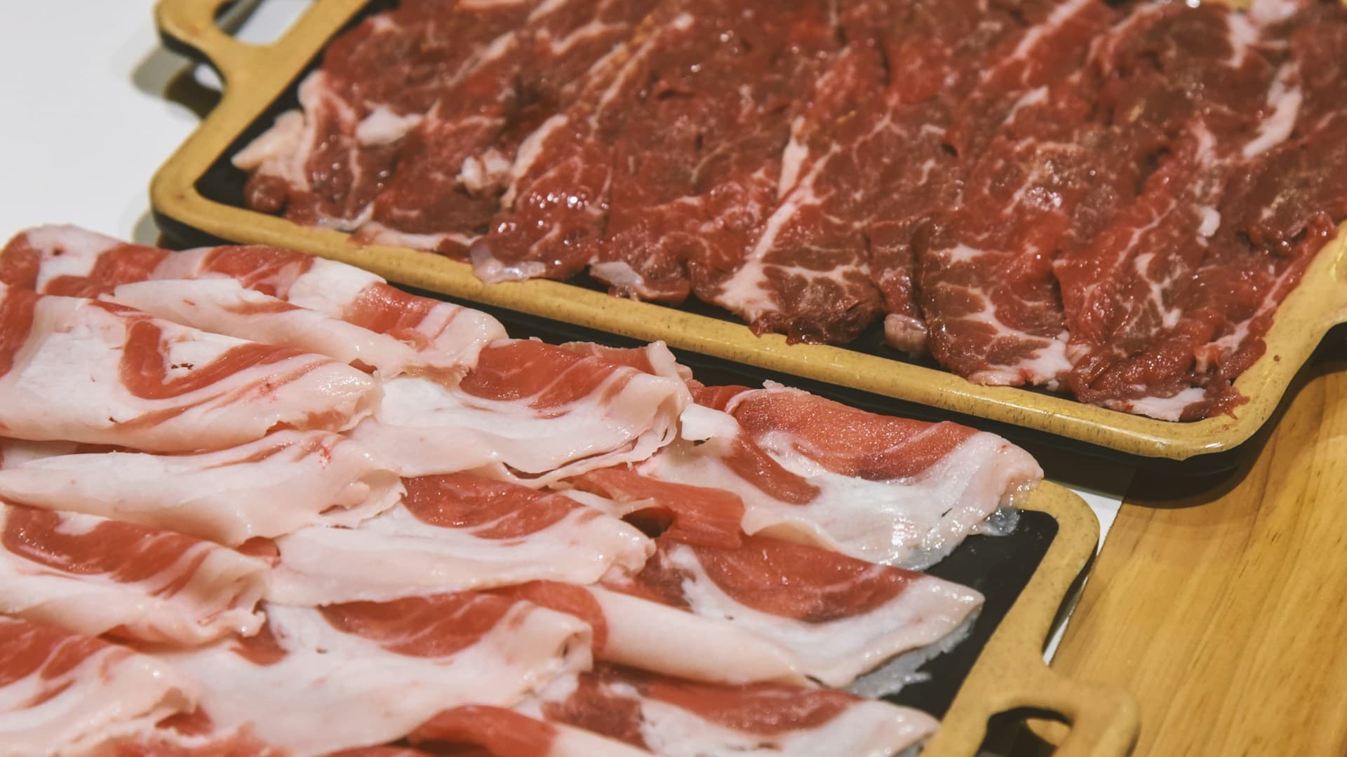 A close-up of different cuts of raw red meat, including beef and lamb, representing ruminant meats for a carnivore diet.