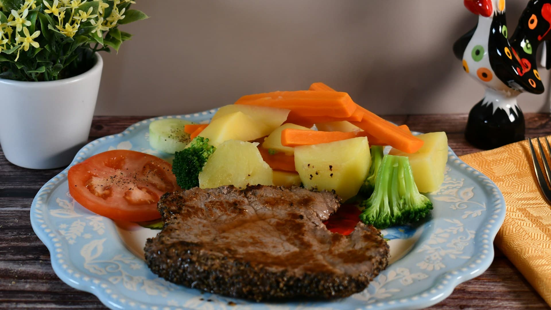 A flat lay of carnivore diet foods including a large ribeye steak, salmon fillet, eggs, and a block of butter.