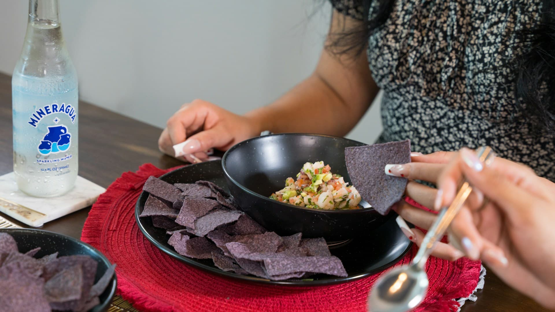 A person portioning a healthy stir fry onto a plate with quinoa, demonstrating a balanced meal.