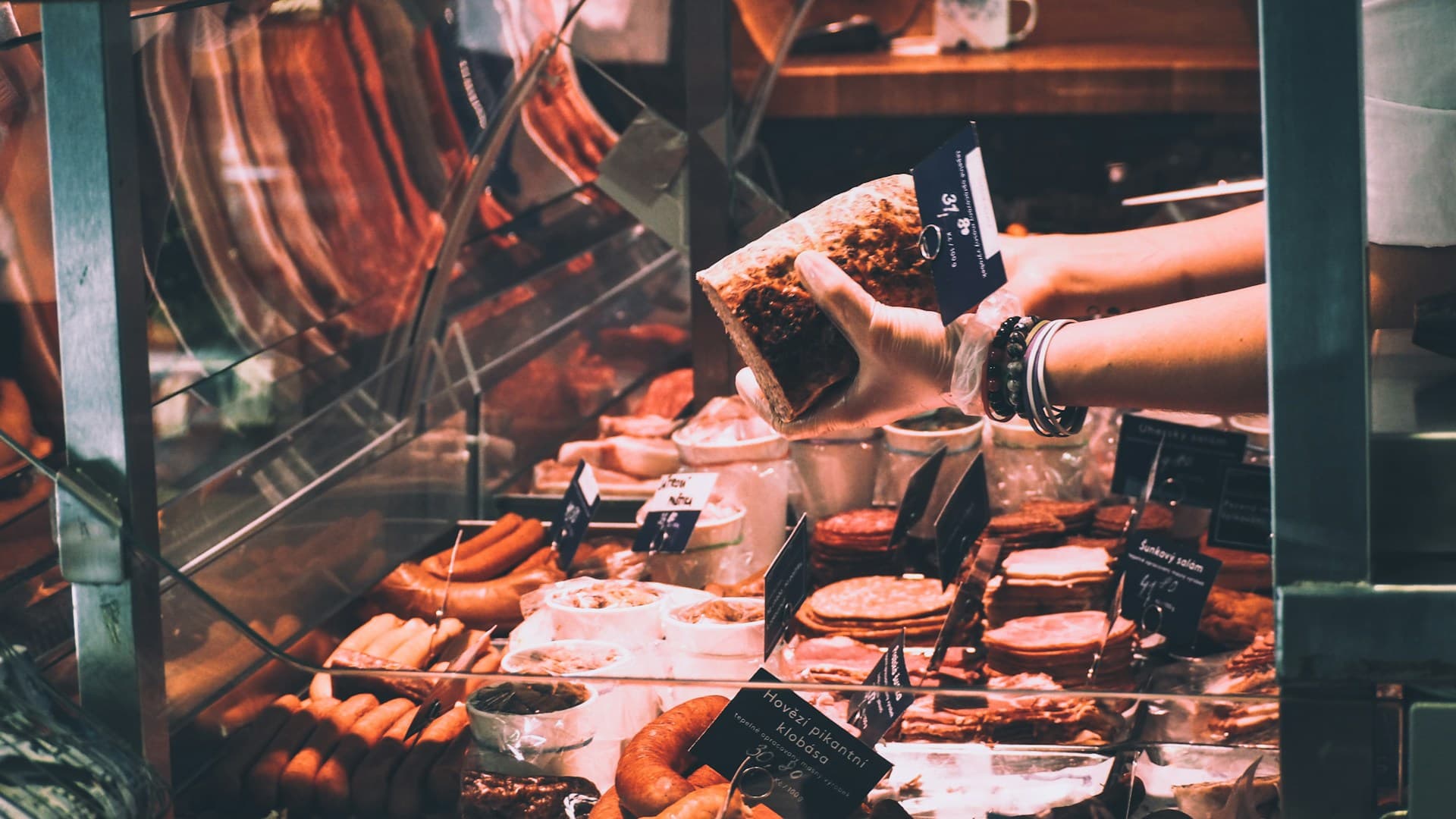 A person thoughtfully looking at a plate of food, considering if the carnivore diet is the right choice for them.