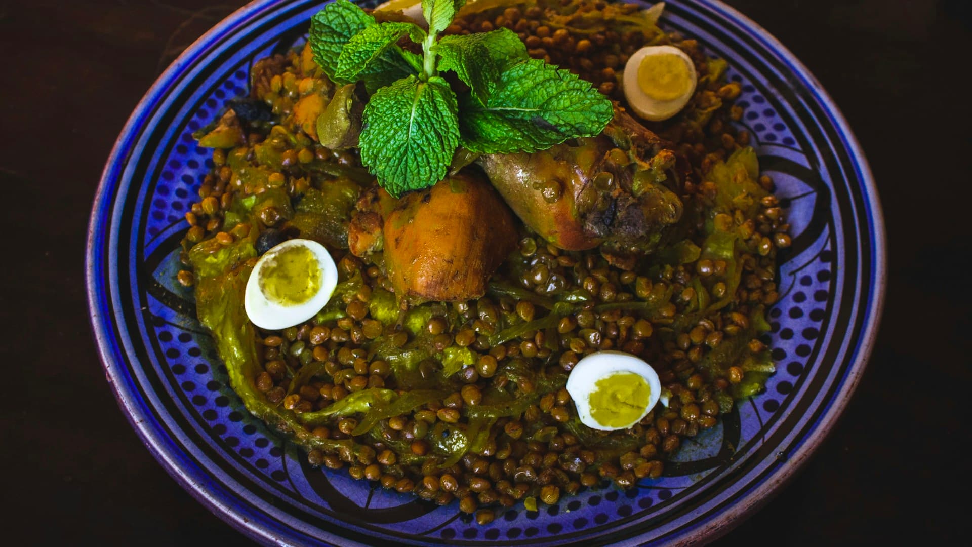 A side dish of quinoa tabbouleh salad in a white bowl, ready to be served with Mediterranean tacos.