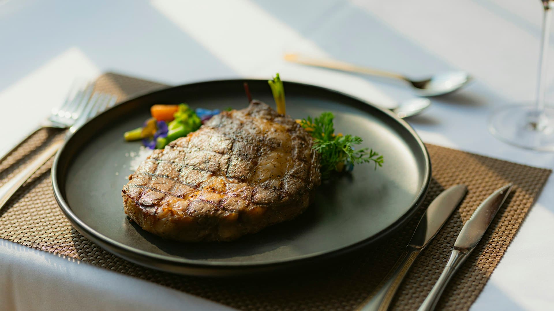 A top-down view of a perfectly cooked steak on a plate, representing the core food of the carnivore diet.