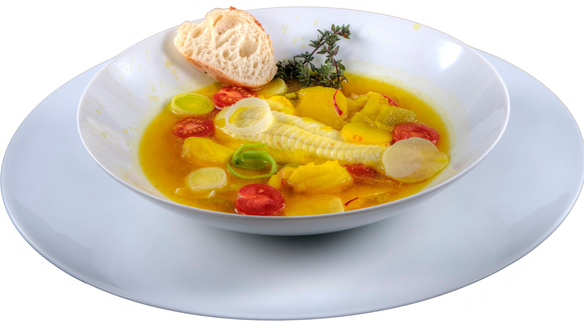 A vibrant bowl of Mediterranean vegetable soup, garnished with fresh herbs and a drizzle of olive oil.