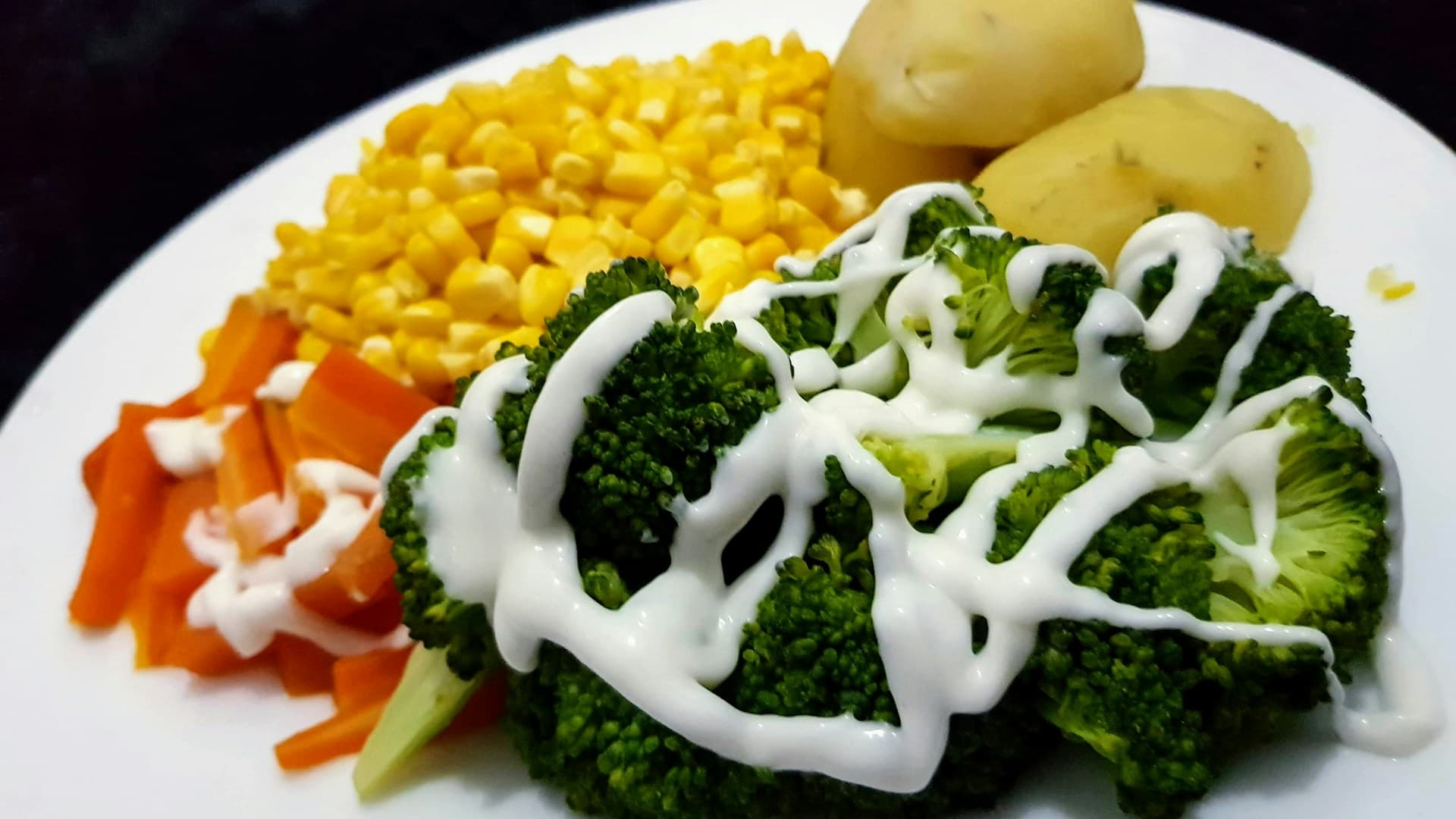 An active person preparing a post-workout meal with chicken, sweet potatoes, and broccoli.
