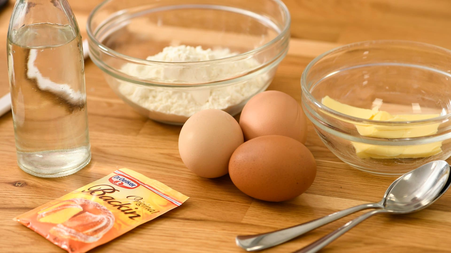 Ingredients for a DIY carnivore shake laid out on a countertop, including bone broth, raw eggs, and salt.